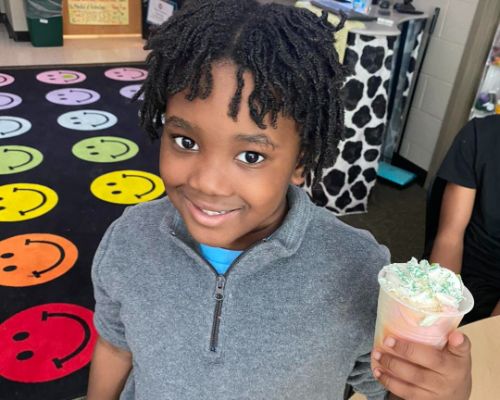  Student holding his snack they made for St. Patrick's Day.