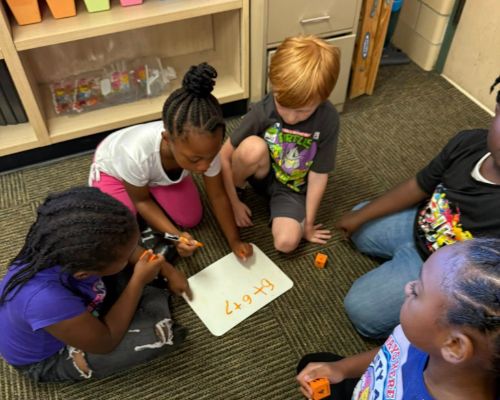  Students working together on math facts
