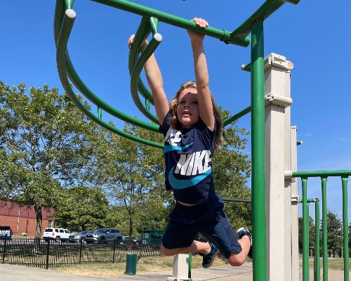  A HWES first grader going across the monkey bars