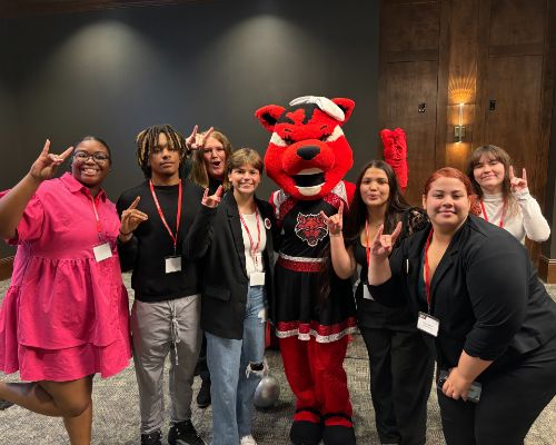  Student "put up their wolves" with Scarlet the Astate mascot