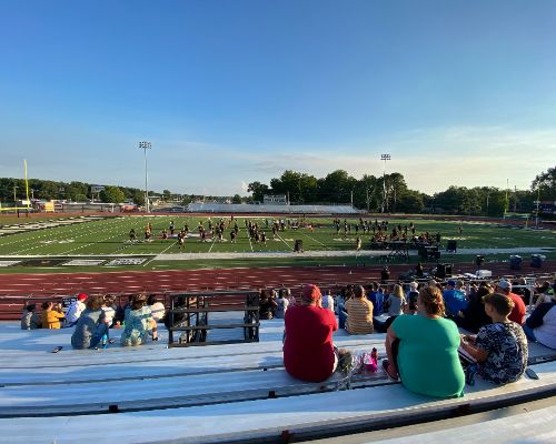  Marching band performs for audience on football field