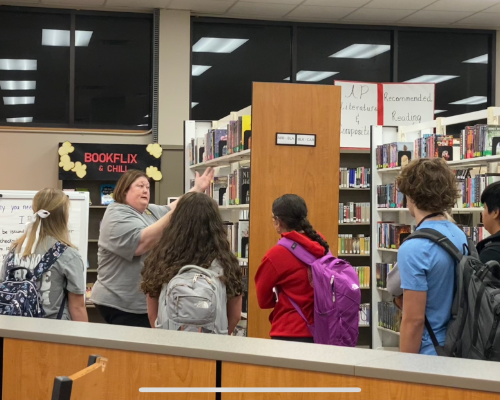  Deb Cook guides students into library shelves