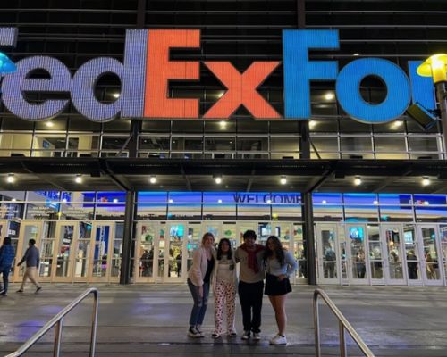  Four students stand in front of FedEx Forum.